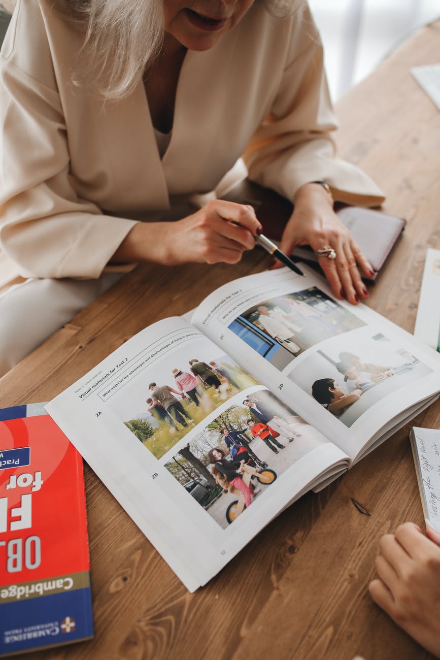 teacher pointing the pictures in a book