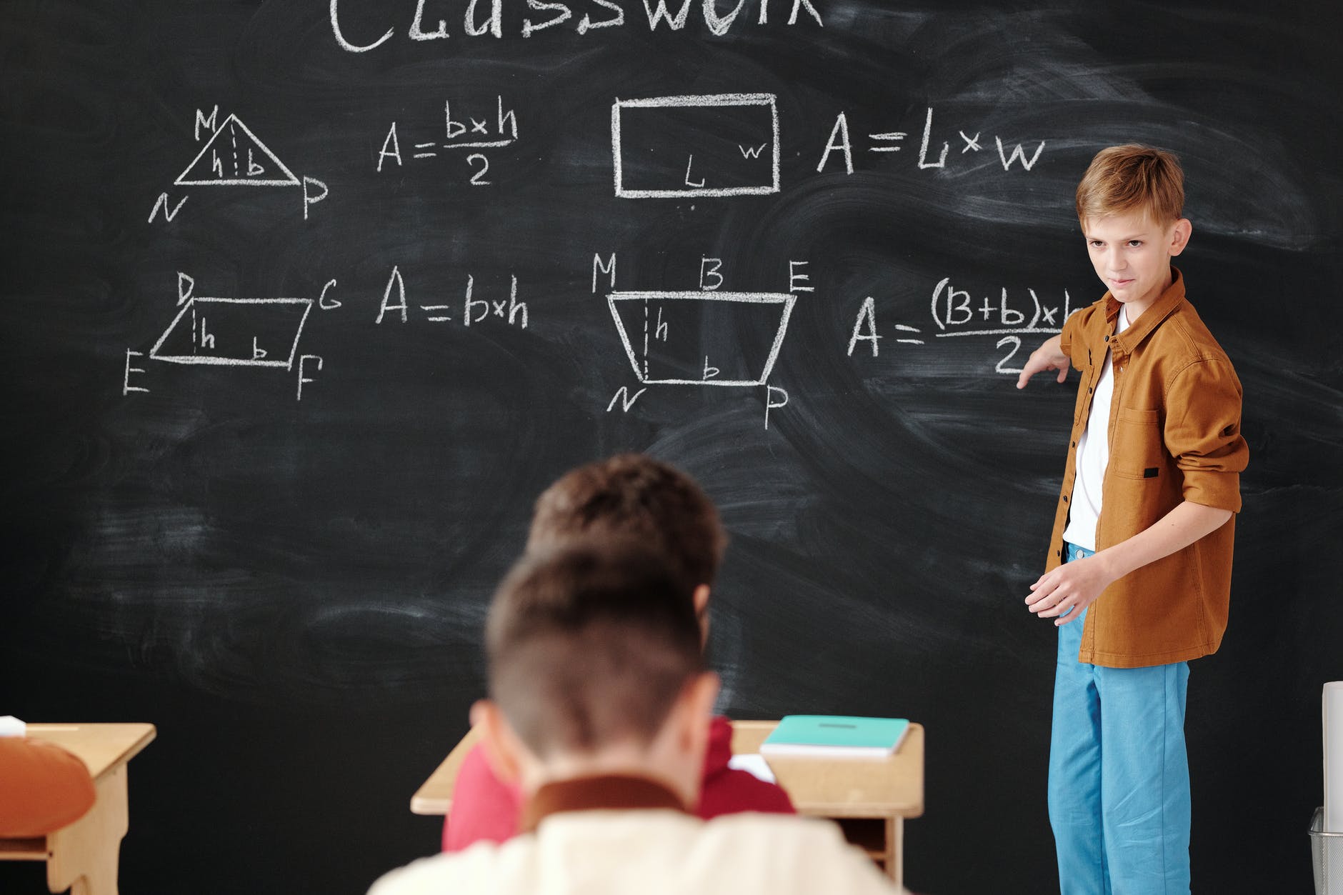 a student discussing in front of the blackboard