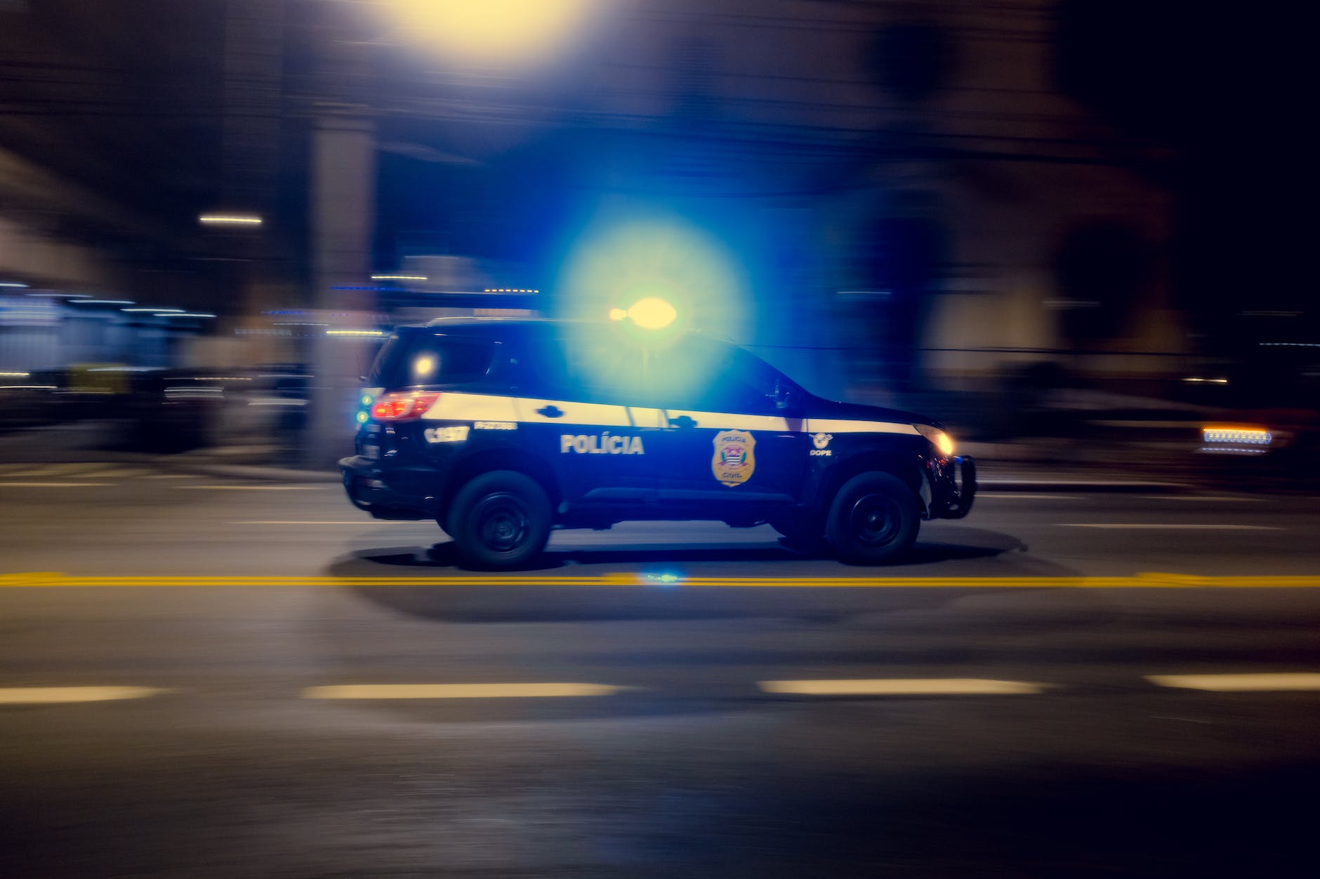 police car driving on night road