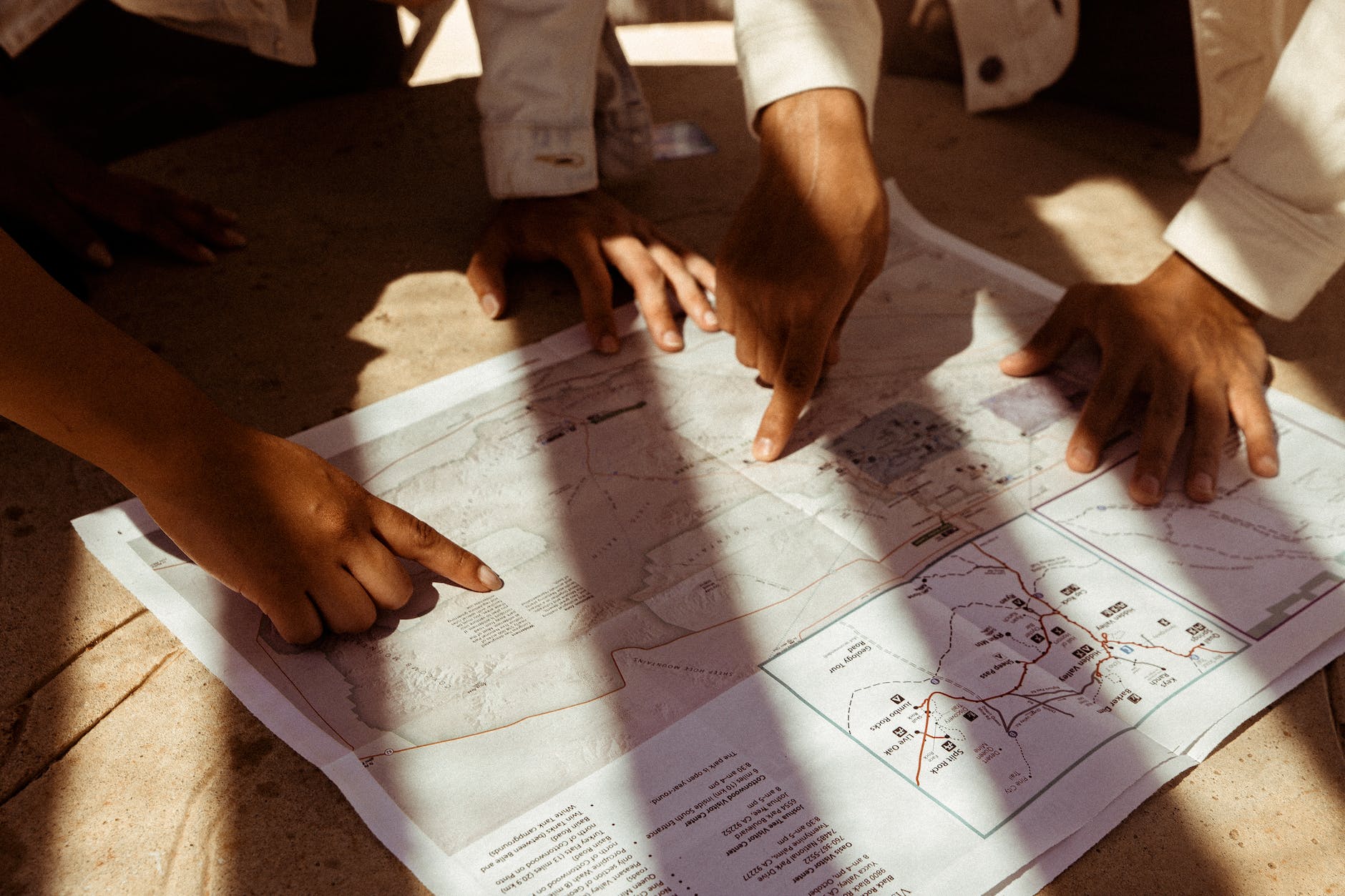 people pointing at a map