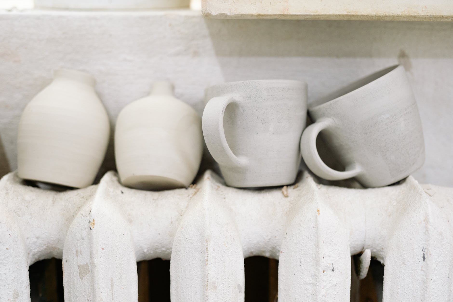 clay mugs drying on a radiator